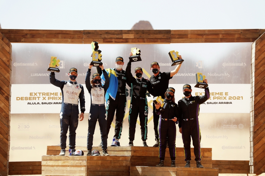 ALULA, SAUDI ARABIA - APRIL 04: Catie Munnings (GBR)/Timmy Hansen (SWE), Andretti United Extreme E, 2nd position, Molly Taylor (AUS)/Johan Kristoffersson (SWE), Rosberg X Racing, 1st position, Nico Rosberg, founder and CEO, Rosberg X Racing, and Cristina Gutierrez (ESP)/Sebastien Loeb (FRA), X44, 3rd position, on the podium during the Desert X-Prix at AlUla on April 04, 2021 in AlUla, Saudi Arabia. (Photo by Sam Bloxham / LAT Images)