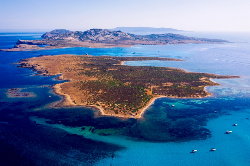 View from above, stunning aerial view of the Isola Piana island and the Asinara island bathed by a beautiful turquoise clear water. Stintino, Sardinia, Italy.