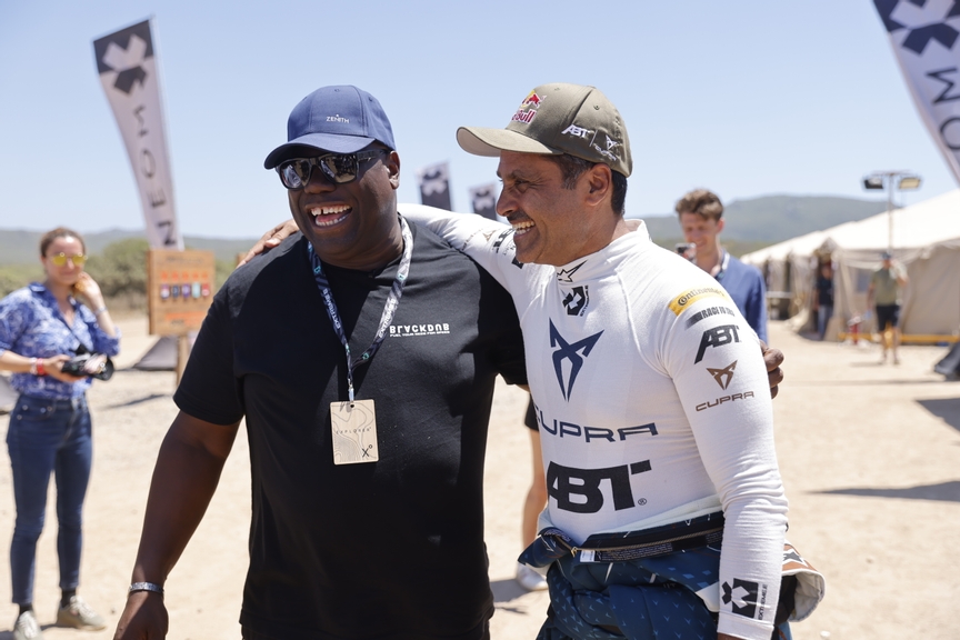 CAPO TEULADA, SARDINIA, ITALY - JULY 10: DJ Carl Cox having a tour of the garages  Nasser Al-Attiyah (QAT), Abt Cupra XE during the Sardinia II on July 10, 2022 in Capo Teulada, Sardinia, Italy. (Photo by Andrew Ferraro / LAT Images)